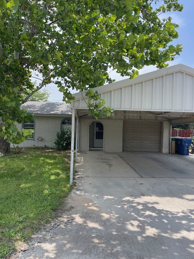 view of front of property with a carport and a garage