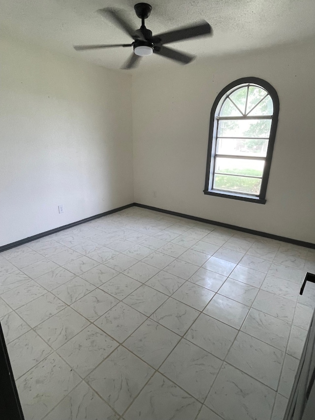 spare room with ceiling fan