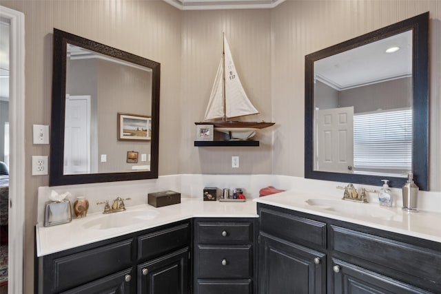 bathroom with crown molding and vanity