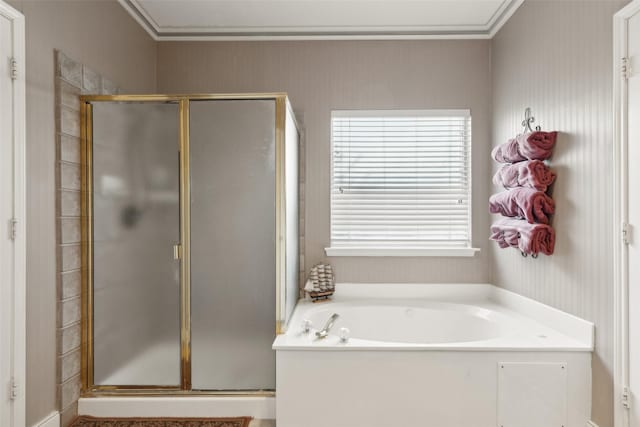 bathroom with a wealth of natural light, shower with separate bathtub, and ornamental molding