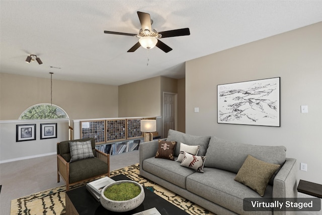 carpeted living room with ceiling fan