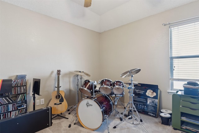 miscellaneous room with ceiling fan and light carpet