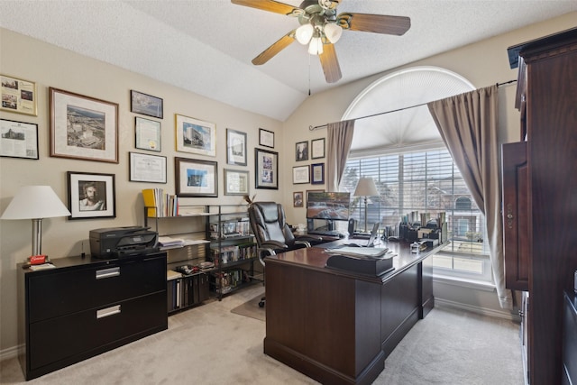 office space featuring ceiling fan, light colored carpet, a textured ceiling, and vaulted ceiling