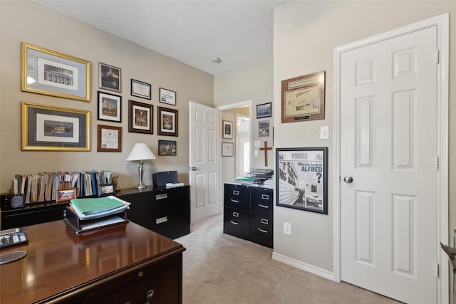 home office featuring a textured ceiling and light carpet