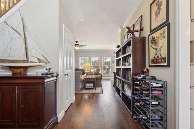 corridor with dark wood-type flooring and ornamental molding