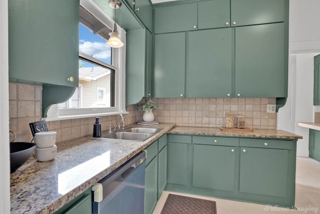 kitchen with dishwasher, sink, green cabinets, light stone counters, and backsplash