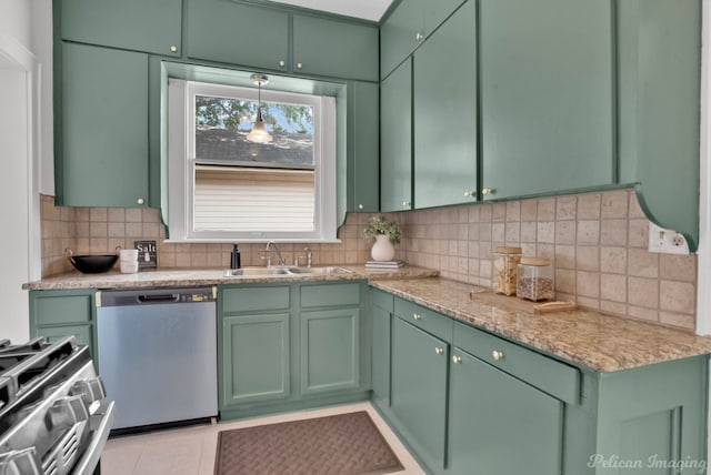 kitchen featuring pendant lighting, sink, appliances with stainless steel finishes, and green cabinetry