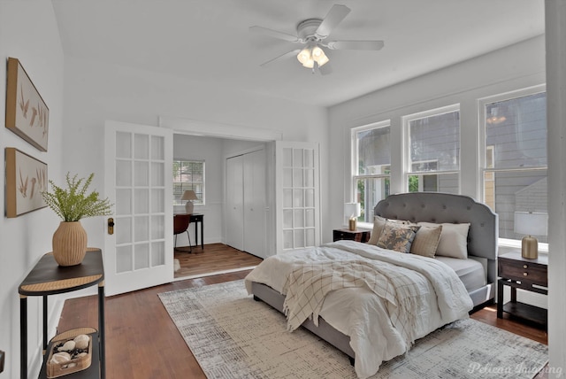 bedroom featuring ceiling fan, a closet, wood-type flooring, and french doors