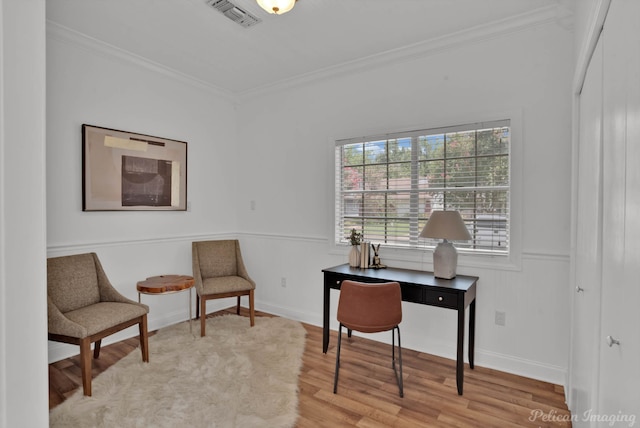 office area with crown molding and light hardwood / wood-style floors