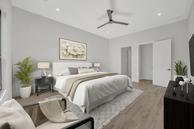 bedroom with ceiling fan and light hardwood / wood-style floors