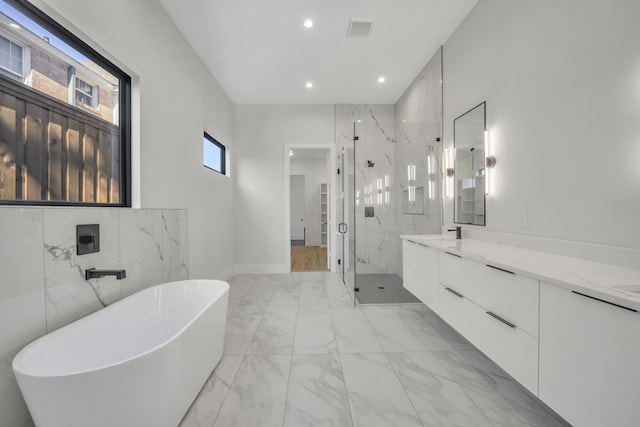 bathroom with vanity and separate shower and tub