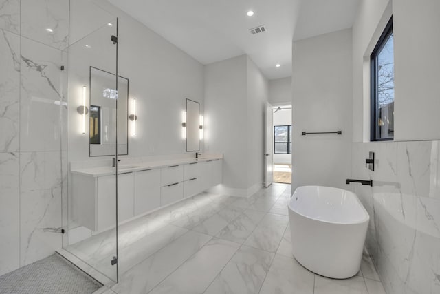 bathroom featuring vanity, tile walls, and independent shower and bath