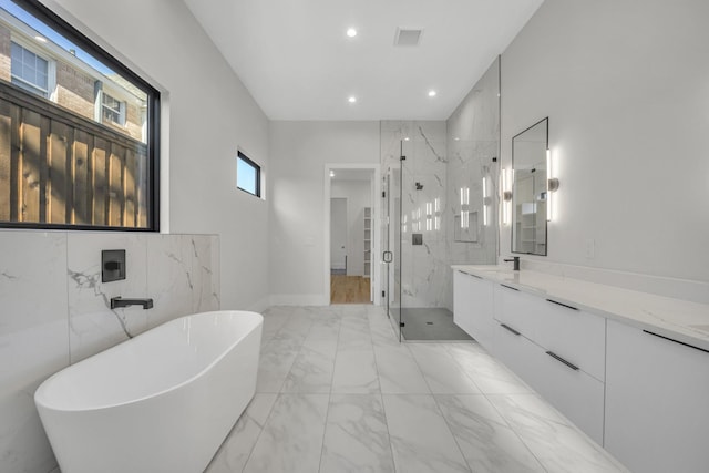 bathroom featuring vanity and shower with separate bathtub