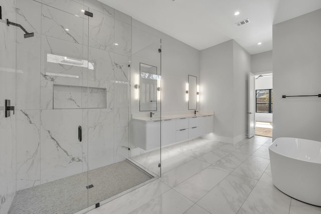 bathroom featuring separate shower and tub and vanity