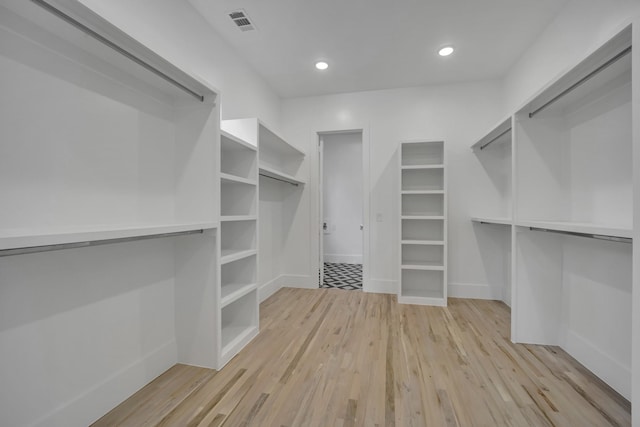 walk in closet featuring light hardwood / wood-style flooring