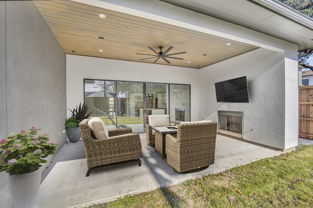 view of patio / terrace featuring an outdoor living space with a fireplace and ceiling fan