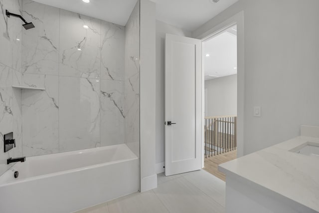 bathroom with vanity, tiled shower / bath combo, and tile patterned floors