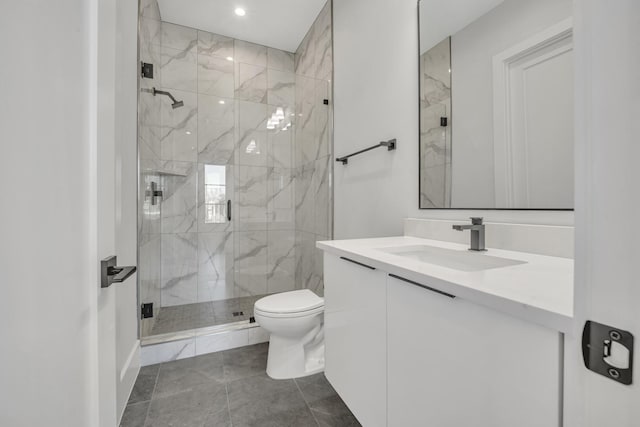 bathroom with vanity, toilet, and a shower with shower door