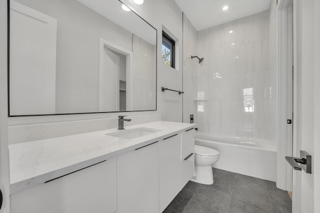 full bathroom featuring toilet, vanity, and tiled shower / bath