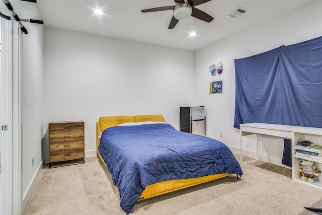 bedroom with ceiling fan and light colored carpet