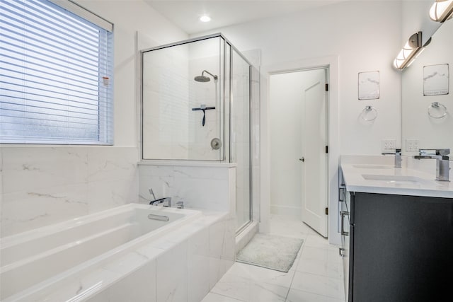 bathroom with vanity and separate shower and tub