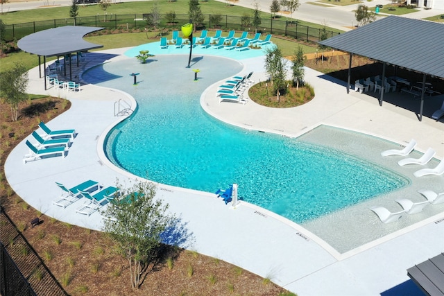 view of pool with a yard and a patio