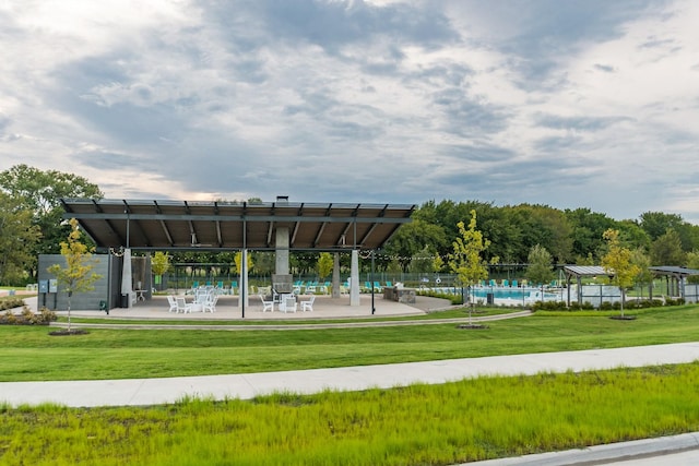 view of community with a yard and a swimming pool