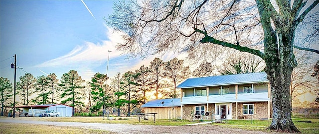 view of front of home with an outbuilding and a front lawn