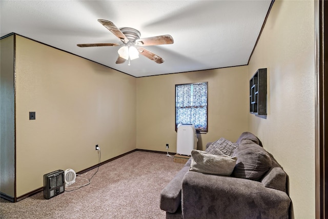 living area featuring carpet floors and ceiling fan