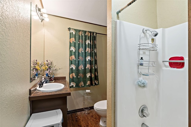 bathroom featuring vanity, toilet, wood-type flooring, and walk in shower