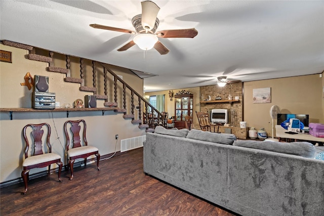 living room with ceiling fan, dark hardwood / wood-style flooring, and a brick fireplace