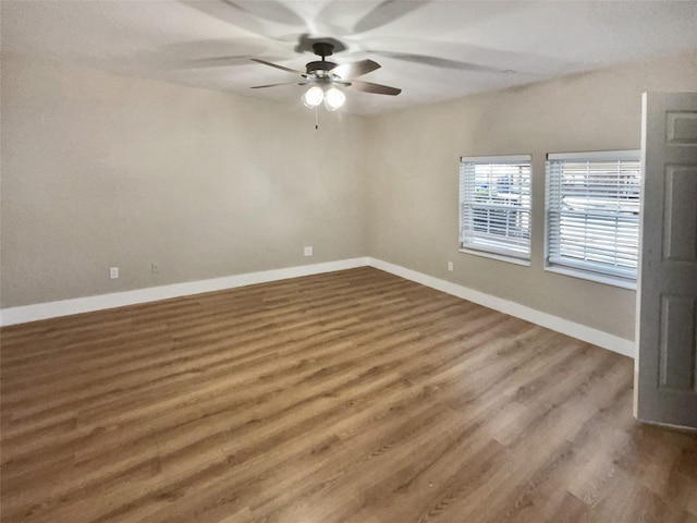 unfurnished room with ceiling fan and dark hardwood / wood-style flooring