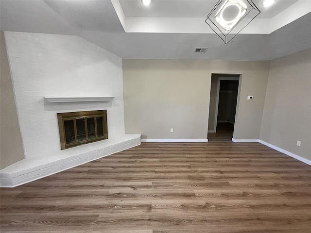 unfurnished living room featuring a fireplace and wood-type flooring