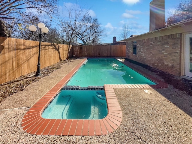 view of swimming pool with an in ground hot tub