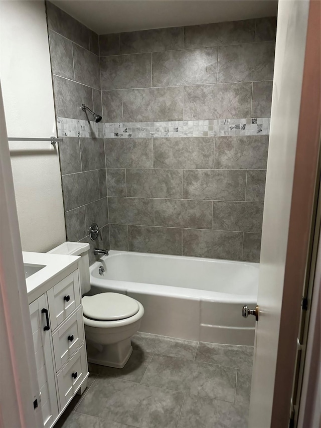 full bath featuring tub / shower combination, toilet, vanity, and tile patterned floors