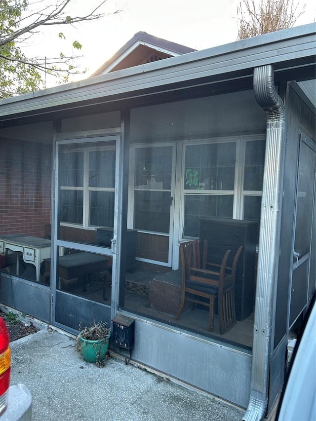 view of home's exterior with a sunroom