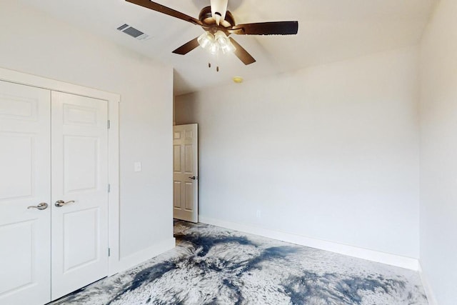 carpeted bedroom featuring a closet and ceiling fan