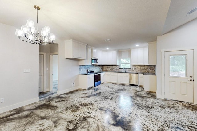 kitchen featuring pendant lighting, decorative backsplash, white cabinetry, stainless steel appliances, and a chandelier