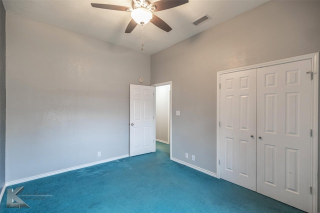 unfurnished bedroom featuring dark carpet, ceiling fan, and a closet