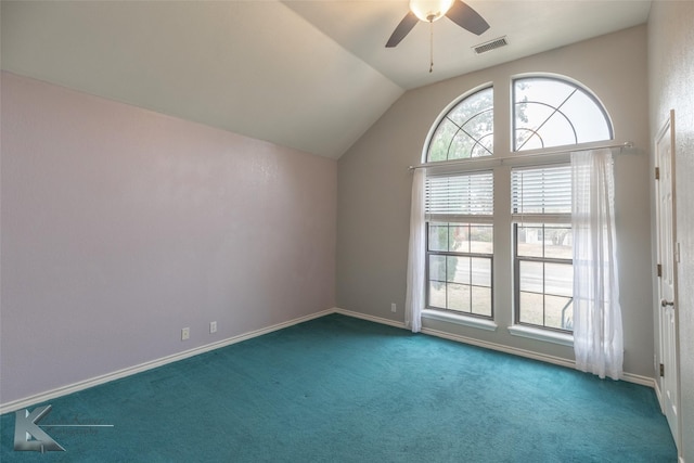 interior space with dark carpet, vaulted ceiling, and ceiling fan