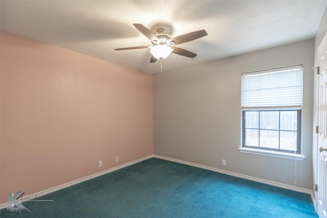 empty room featuring dark colored carpet and ceiling fan