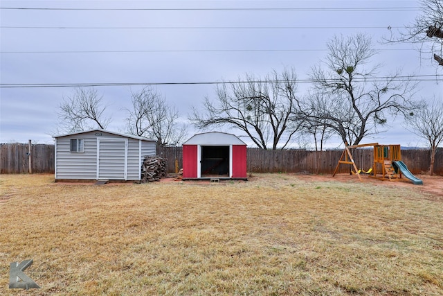 view of yard with a shed and a playground