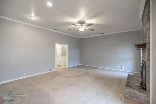 unfurnished living room featuring a brick fireplace, ornamental molding, light colored carpet, and ceiling fan