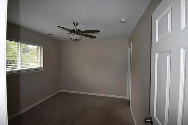 carpeted spare room with ceiling fan