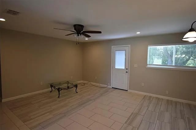 spare room featuring ceiling fan and light hardwood / wood-style flooring