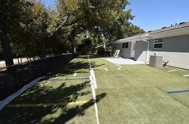 view of yard featuring central AC unit and a patio area