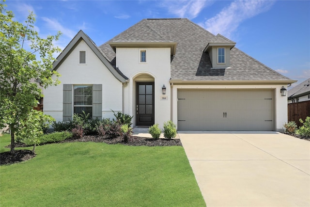 view of front of home with a front yard and a garage