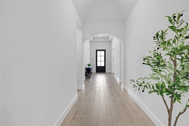 corridor with light hardwood / wood-style floors