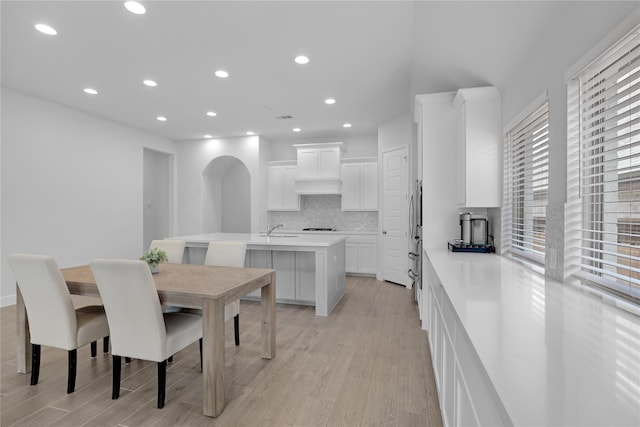 dining space with sink and light hardwood / wood-style floors