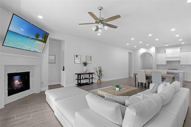 living room featuring light hardwood / wood-style flooring and ceiling fan